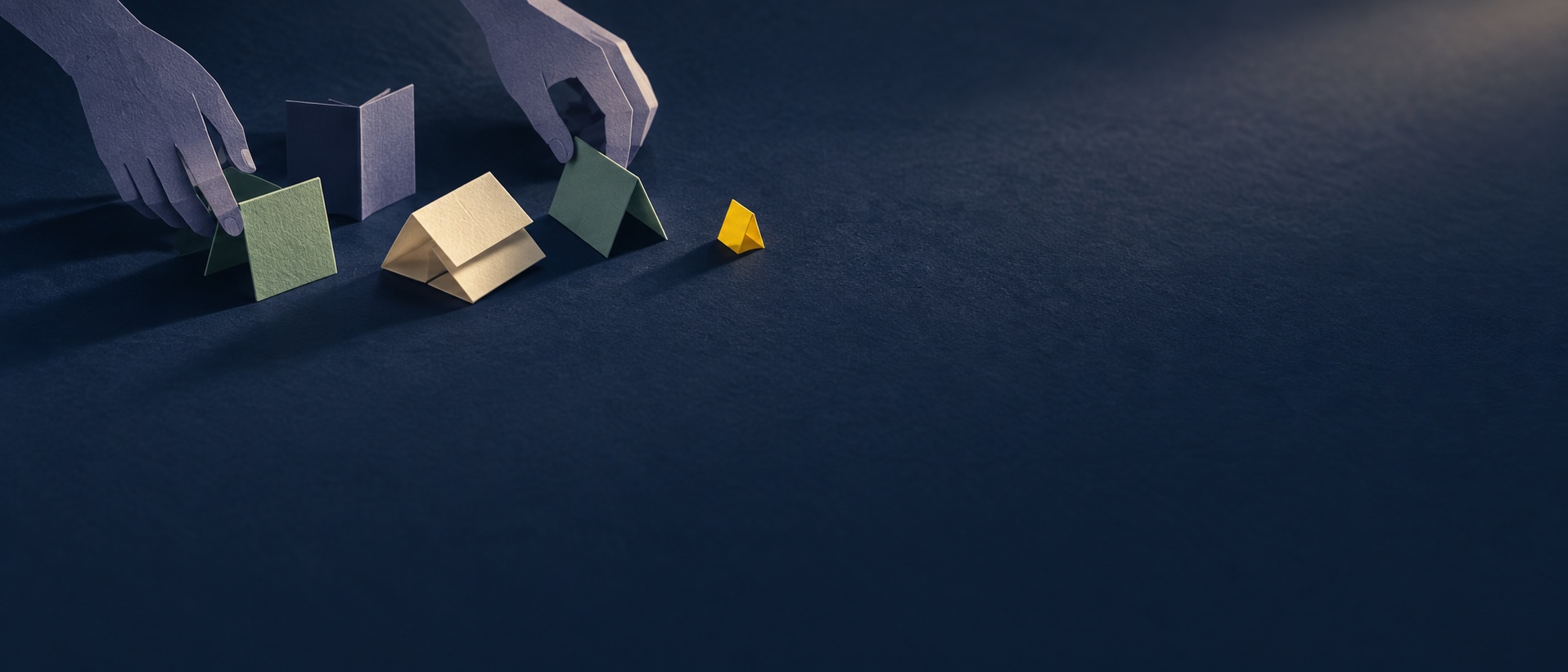 Paper hands experiment with small folded structures on a dark blue surface.
