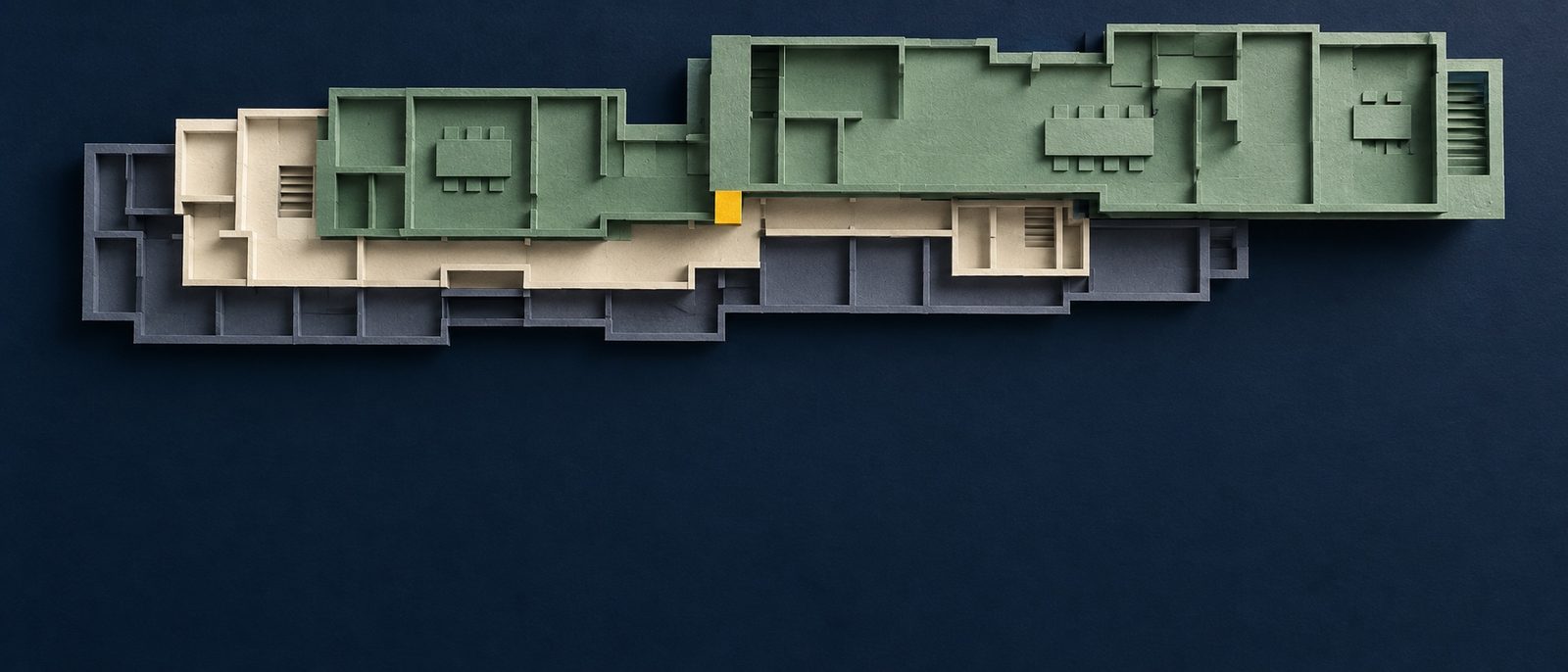 Layered paper floor plans shift into a new configuration, suggesting software being rebuilt for a changing purpose.